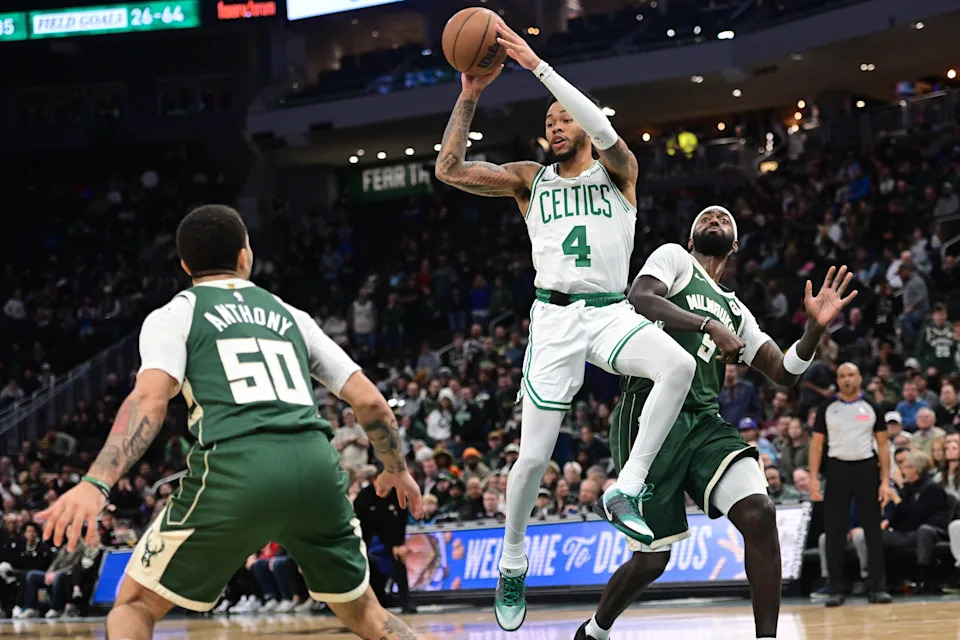Dec 11, 2025; Milwaukee, Wisconsin, USA; Boston Celtics guard Anfernee Simons (4) looks to pass the ball against Milwaukee Bucks forward Bobby Portis (9) and guard Cole Anthony (50) in the fourth quarter at Fiserv Forum. Mandatory Credit: Benny Sieu-Imagn Images