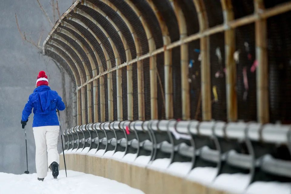 A person cross country skies during a snowstorm, Sunday, Jan. 25, 2026, in Arlington, Va.