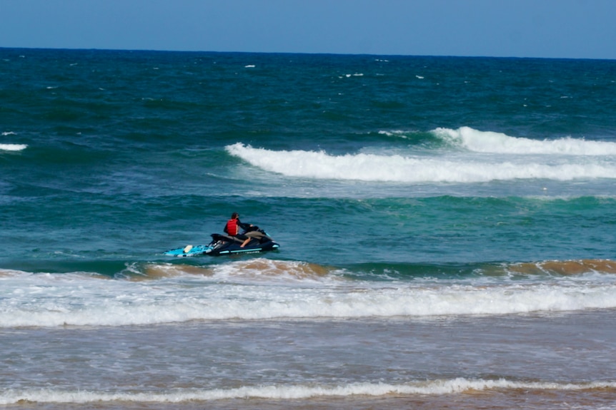 A jet ski in beach shallows.
