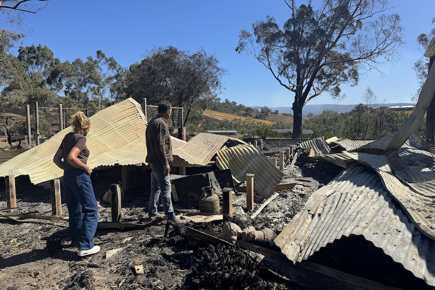 The Harpers inspent the ruins of their home