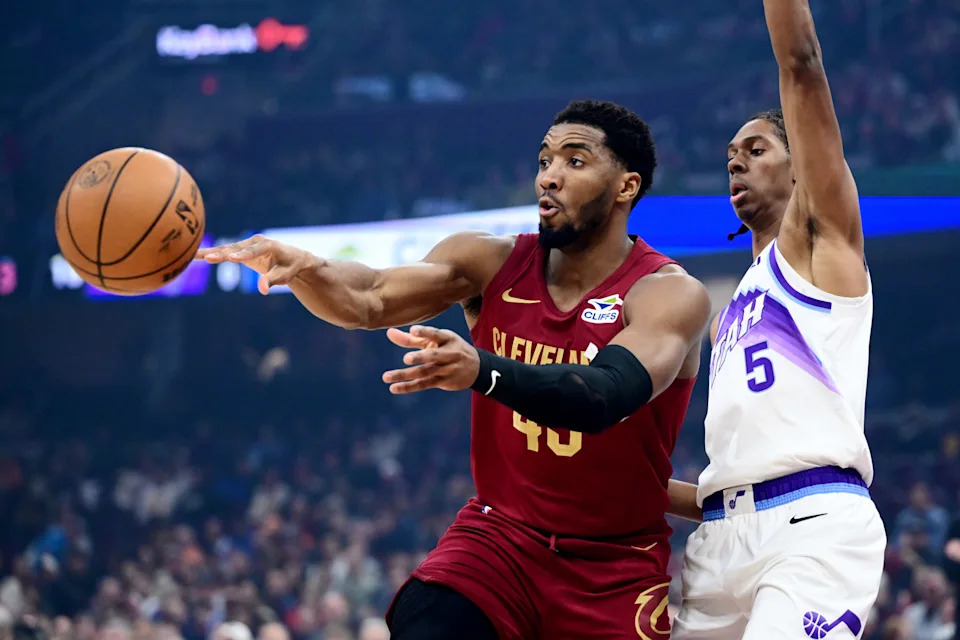 Jan 12, 2026; Cleveland, Ohio, USA; Cleveland Cavaliers guard Donovan Mitchell (45) passes as Utah Jazz forward Cody Williams (5) defends during the first quarter at Rocket Arena. Mandatory Credit: Ken Blaze-Imagn Images
