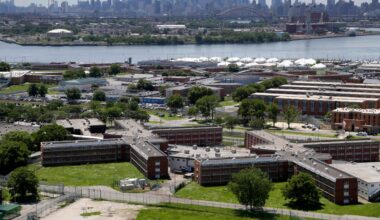 This June 20, 2014 file photo shows the Rikers Island jail complex in New York with the Manhattan skyline in the background. (AP Photo/Seth Wenig, File)