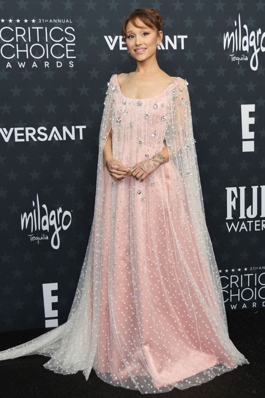 Ariana Grande continues to embrace her “Wicked” character Glinda’s signature pink — this time in a custom cape gown by Alberta Ferretti.