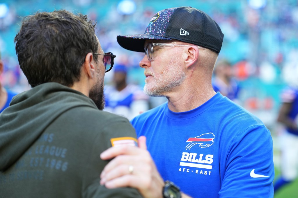 Head coaches Mike McDaniel and Sean McDermott speaking after a game.