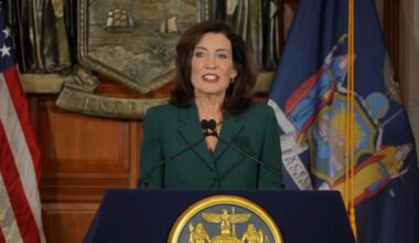 gov. kathy hochul gives state budget speech behind podium at state capitol