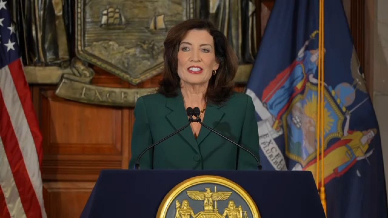 gov. kathy hochul gives state budget speech behind podium at state capitol