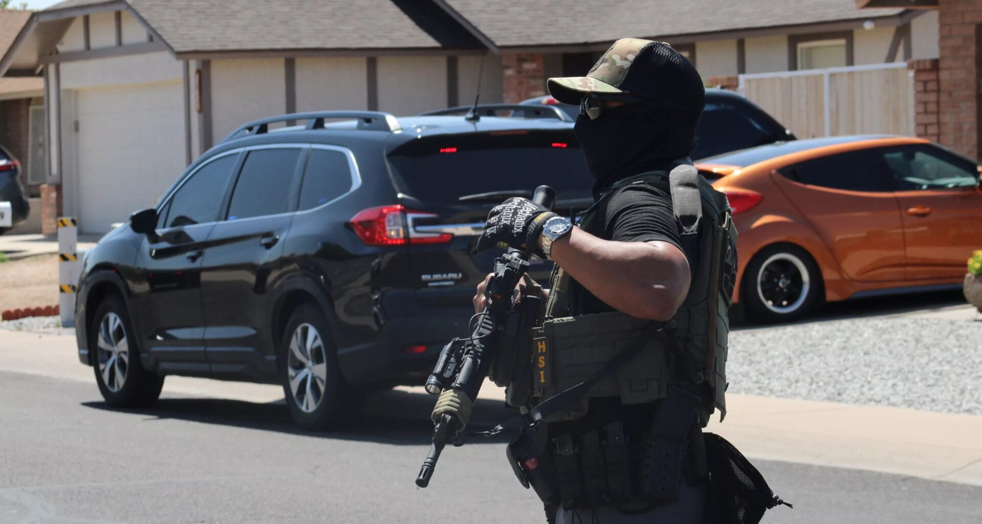 a masked HSI agent with a rifel