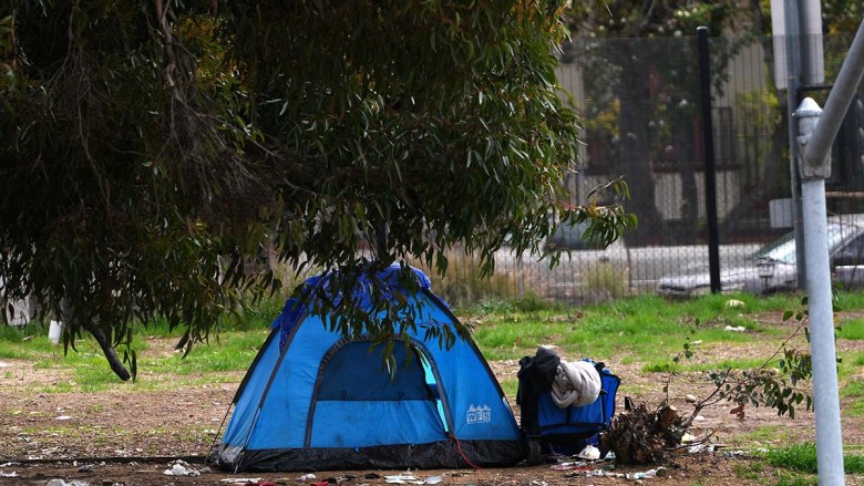 A homeless tent near the freeway. (Photo by Chris Stone/Times of San Diego)