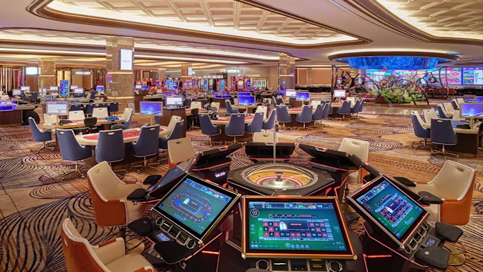 A spacious casino floor at Inspire Resort Korea with rows of gaming tables, slot machines and electronic roulette stations