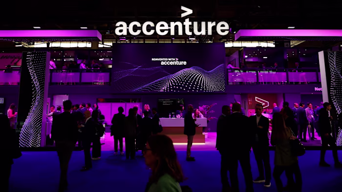 The Accenture logo is displayed above a busy pavilion with people networking and talking.