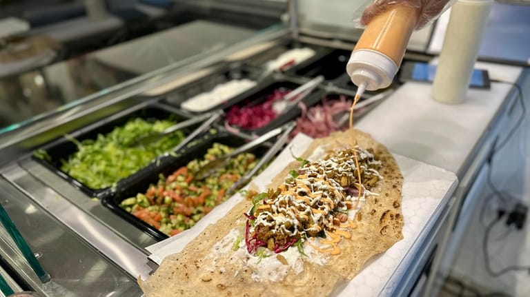 A chicken shawarma wrap in progress at Shawarma Bay in...