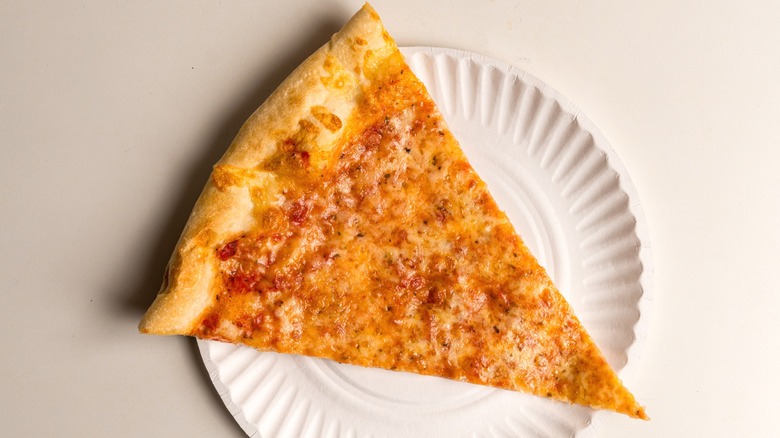 A slice of plain pizza on a paper plate.