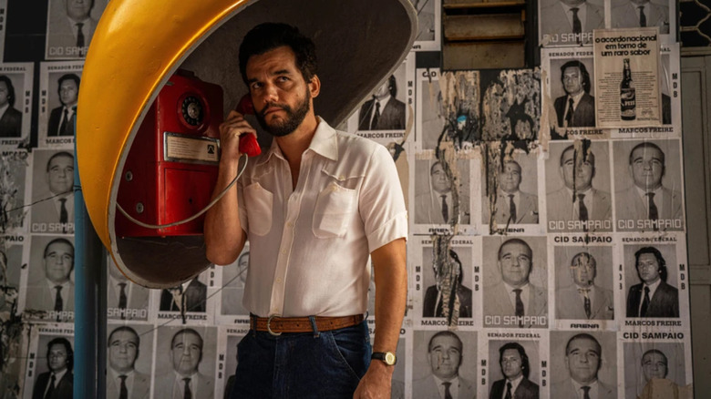 Armando on the phone in front of wanted posters in The Secret Agent