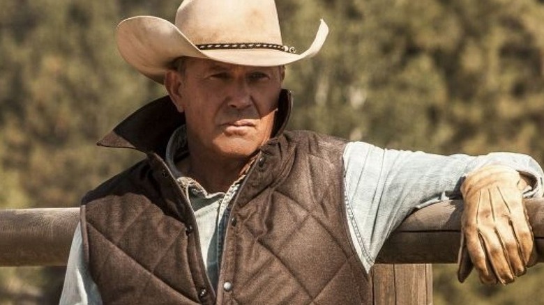 John Dutton sits at a fence in a cowboy hat on Yellowstone (2018-2024)