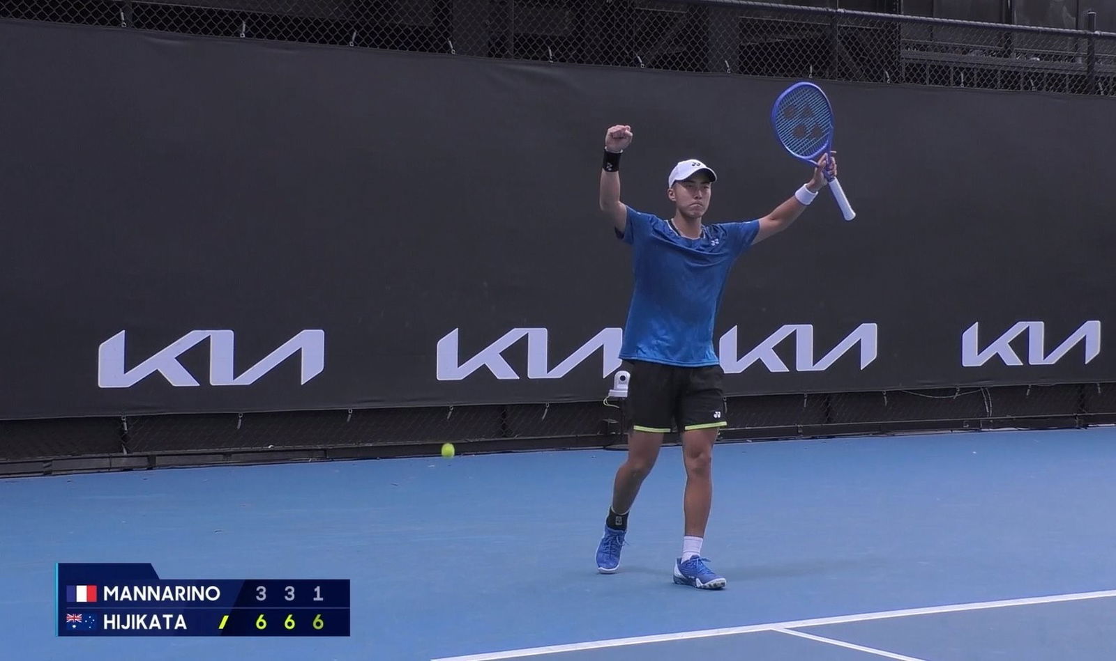 Rinky Hijikata celebrates with two hands in the air