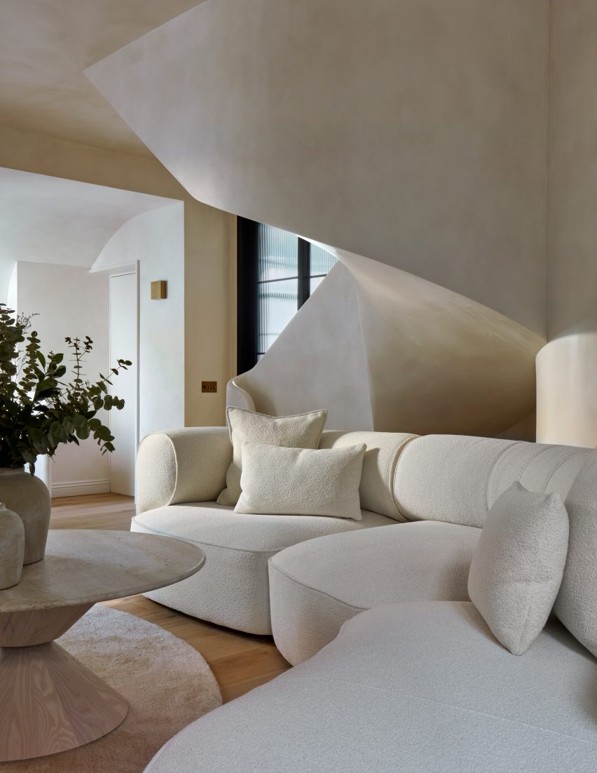 White spiral staircase in a minimalist living room