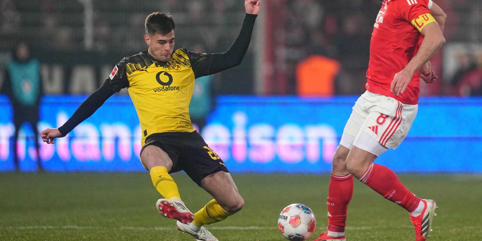 Anselmino of Borussia Dortmund makes a tackle