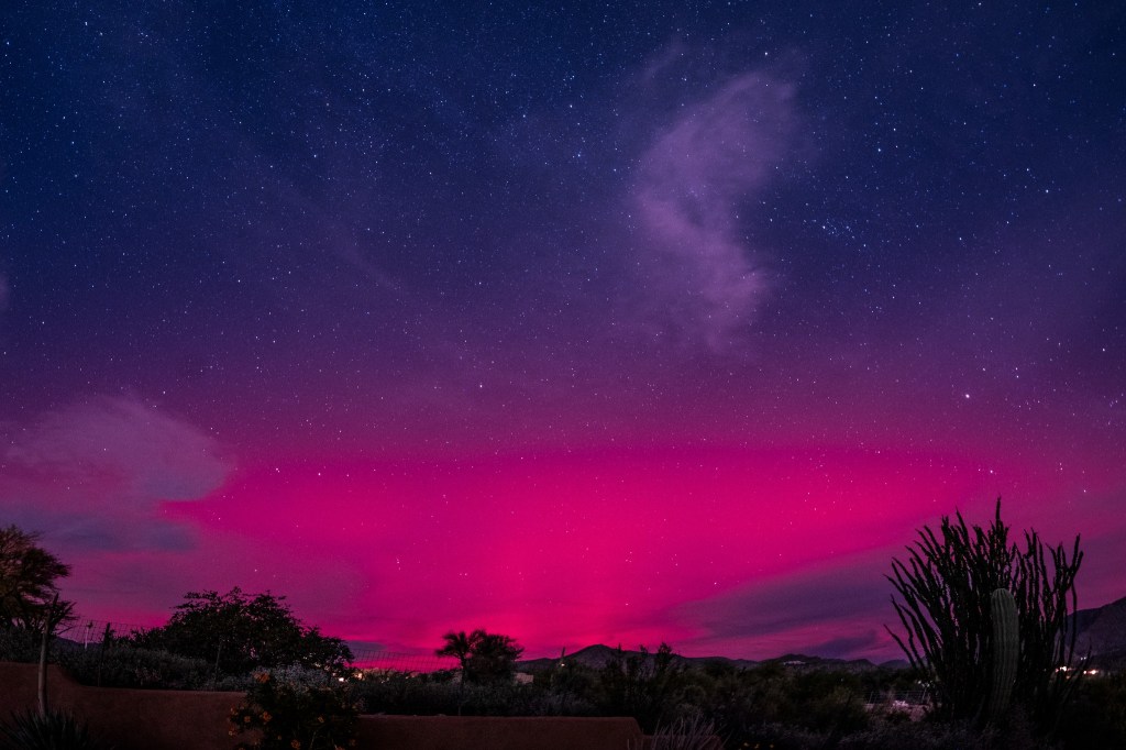 Purple auroral glow from the northern lights appears over Cave Creek, Arizona, during a 2025 geomagnetic storm.