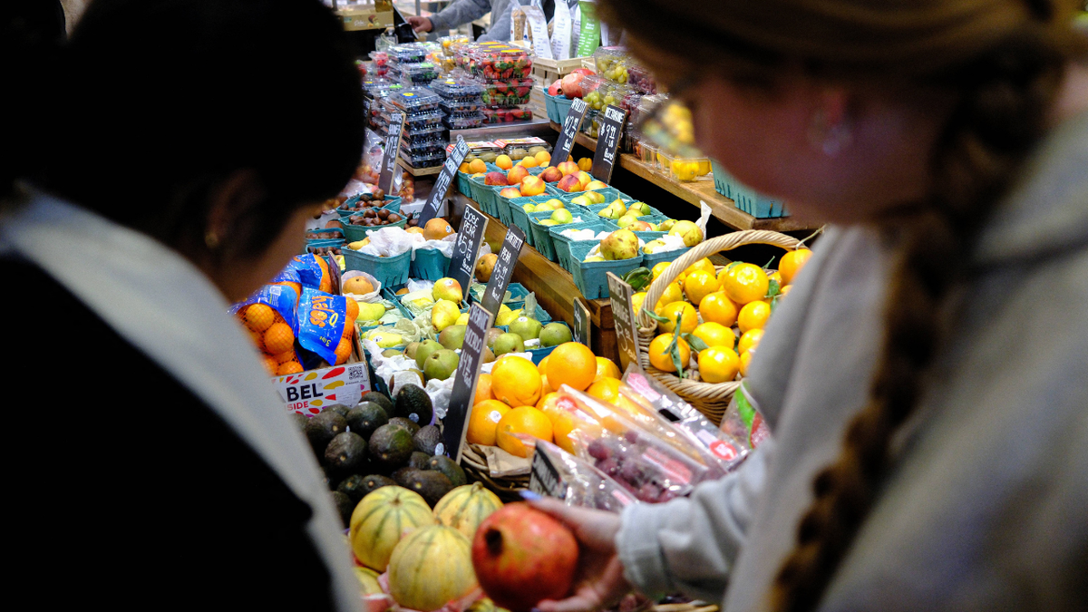 People shop for produce at a grocery store in New York City.