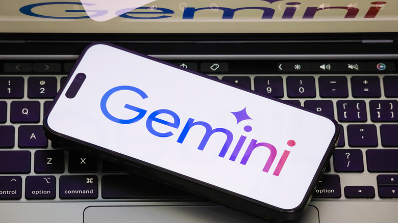 A close-up of a smartphone displaying the Gemini logo on a white screen
