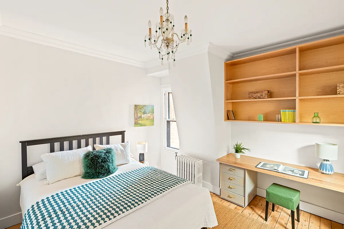 bedroom with pale wood floor, room for a desk