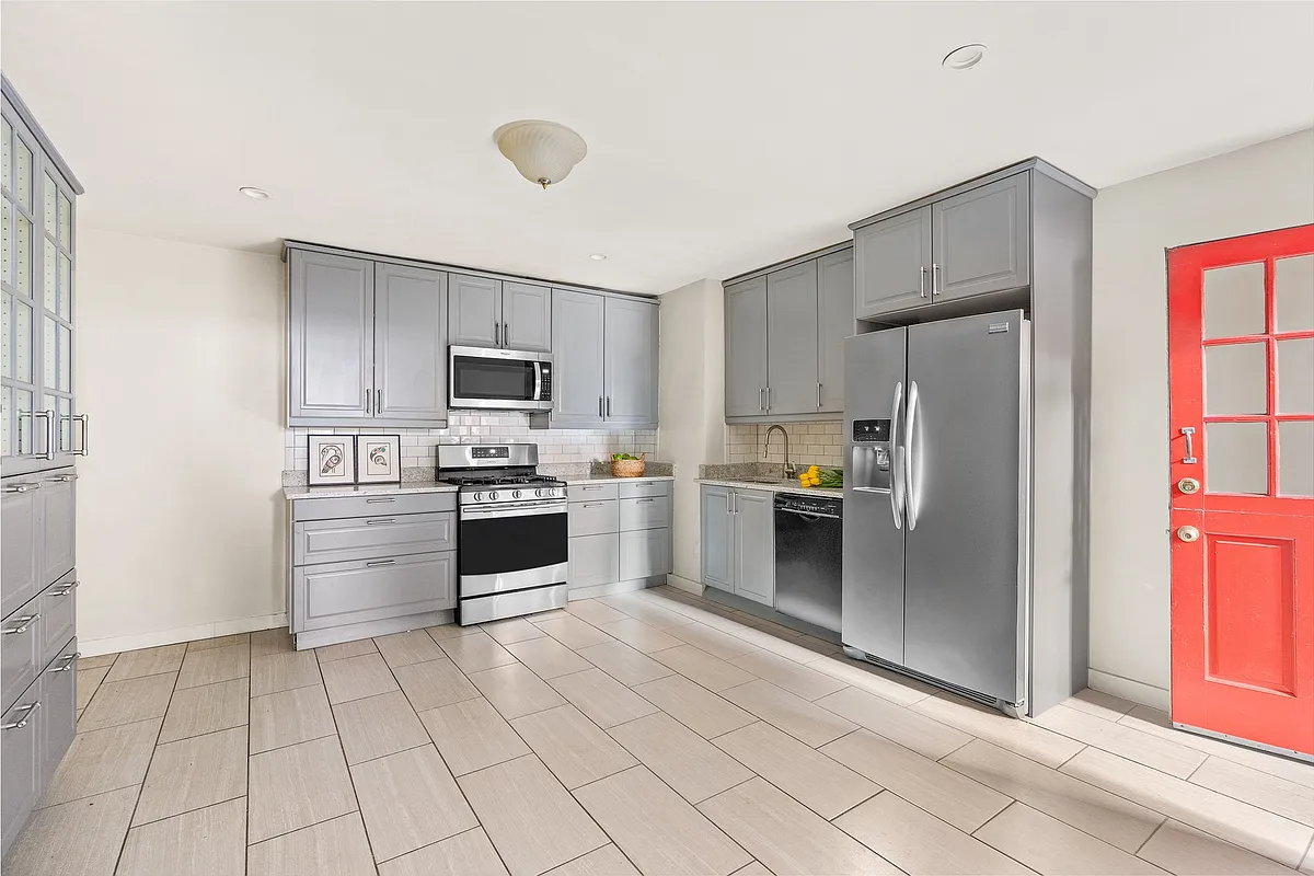 garden level kitchen with gray cabinets, tile floor