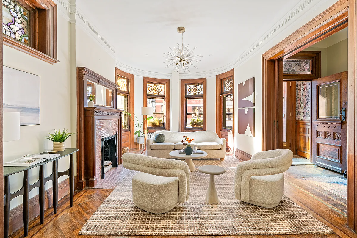 parlor with wood floors, mantel, stained glass