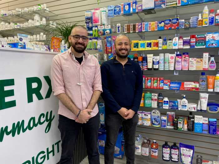 two men standing in a pharmacy aisle