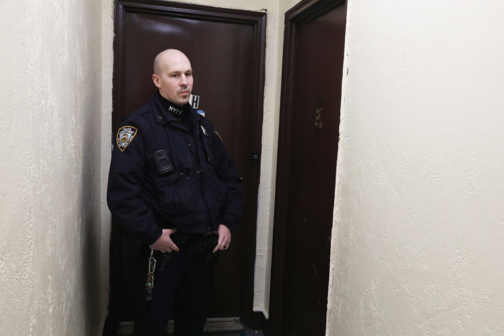 Police officer from the 46th precinct near an apartment in the Bronx, New York.