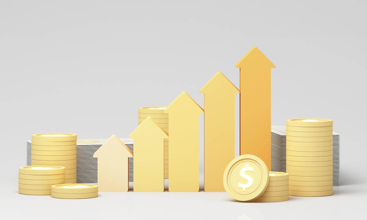 Gold colored arrows pointing upwards in a row and increasing in height with coins stacked next to them depicting a bull market, positive financial gains