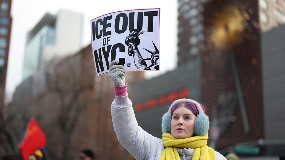 Anti-ICE protester in New York holding sign