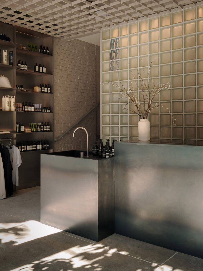 The light-filled reception of Recess bathhouse, which includes a raw steel counter and sink