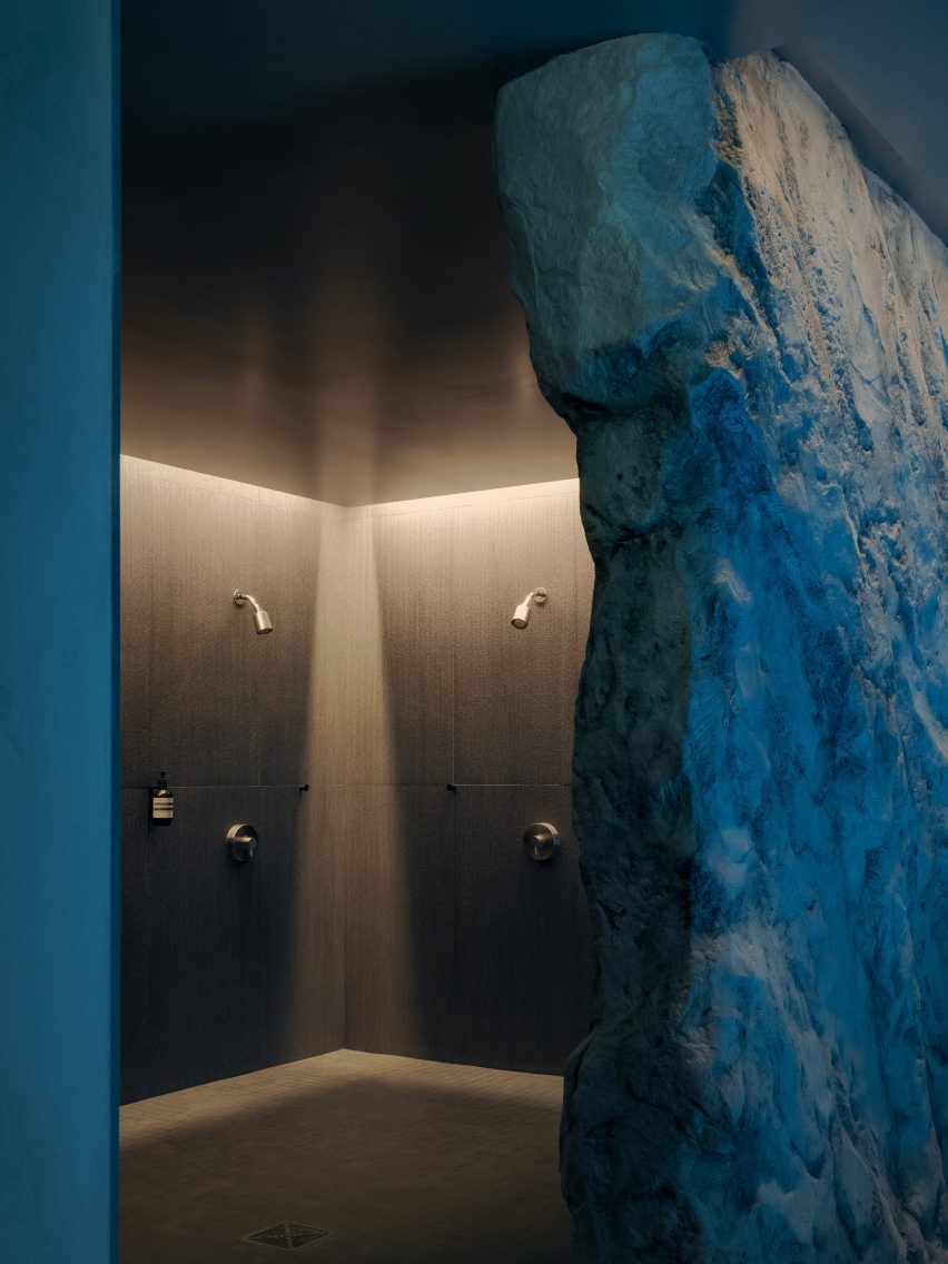 A wall with a rock-like texture partially disguises a shower