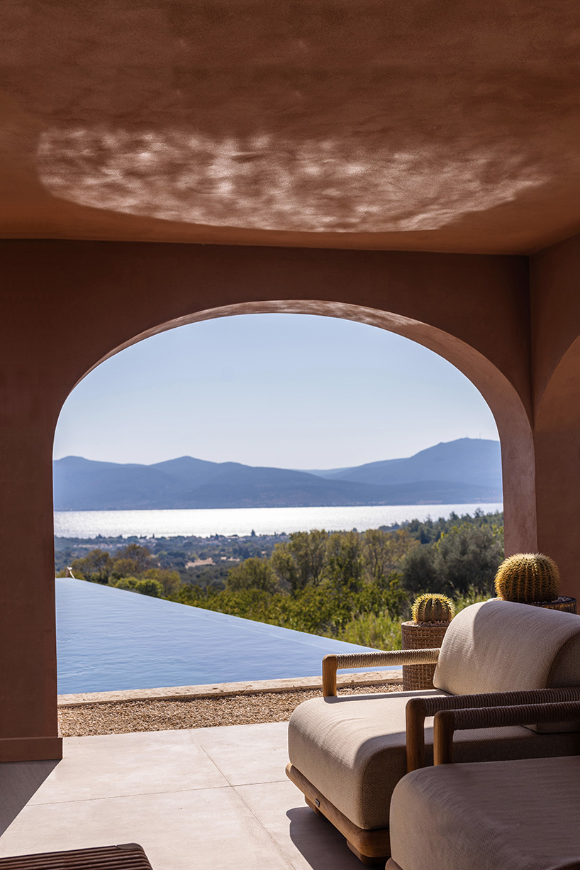 lime-washed facade in terracotta tones enfolds urla family home in turkey