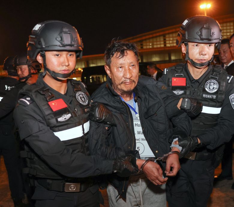 Wei Huairen is handed over to Chinese police officers in Naypyidaw, Myanmar, on January 30, 2024.