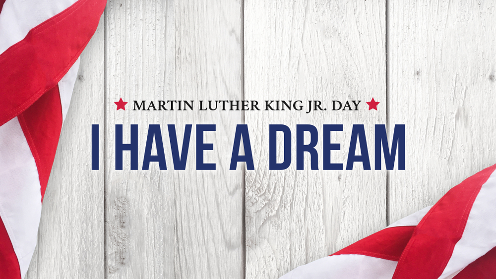 Martin Luther King Jr. Day "I have a dream" text in blue against a wood grain background and American Flag at the edges.