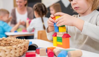 Kindergarten children playing with colorful building blocks. Healthy learning environment. Learning through play.