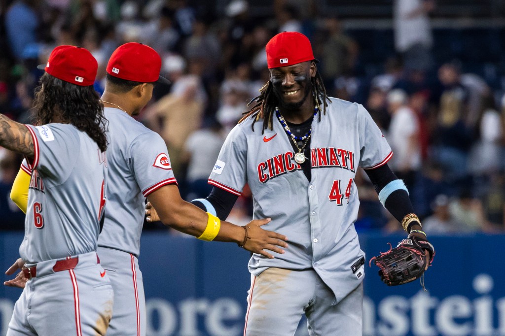 Cincinnati Reds shortstop Elly De La Cruz smiling after the final out of the 9th inning.