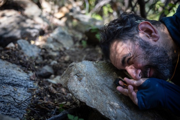 Shahan Derkarabetian, the curator of entomology at the museum, uses a magnifying glass to look at a millipede in the Sierra de las Cacachilas on Tuesday, Oct. 28, 2025. (Ana Ramirez / The San Diego Union-Tribune)
