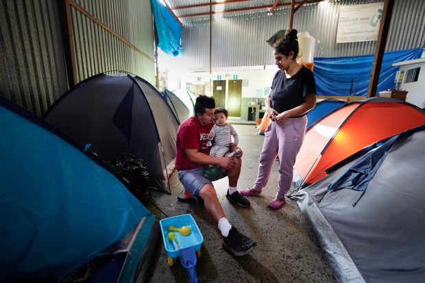 Edgar Villanueva and his wife, Karen Garcia, along with their baby boy, Nain Villanueva Garcia, have been living at the Juventud 2000 shelter in Tijuana since late 2025. They were one of 10 families from Mexico staying there. The other tents, which a year ago were full, now sit mostly empty. (Nelvin C. Cepeda / The San Diego Union-Tribune)