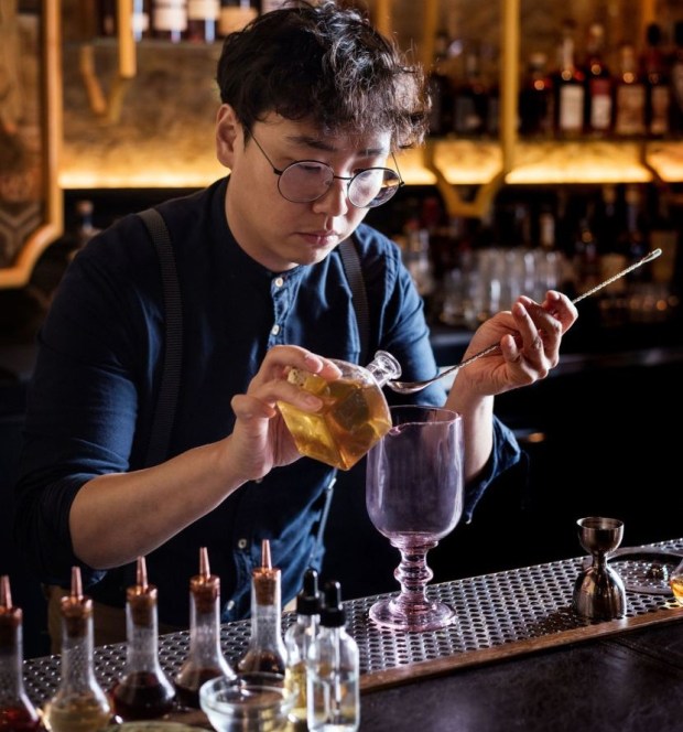 Realm of the 52 Remedies beverage director Chris Lee makes a potion-style drink at the Convoy Street speakeasy in 2018. Realm earned a 2026 James Beard semifinalist national nomination for Outstanding Bar on Wednesday, Jan. 21. (Auda & Coudayre Photography)