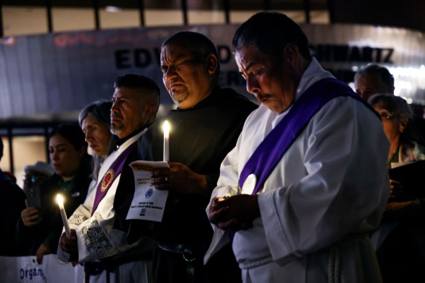 Clergymen and other Worshipers stand outside of the Fedral Courthouse during a vigil for immigrants held in ICE detiontion on Thursday, Nov. 13, 2025 in Downtown. Catholic, Jewish, Unitarian Universalist, Methodist, and multi-faith leaders shared prayers and reflections calling to protect immigrants, to stand with the stranger, and to call out injustice in our community.(Photo by Sandy Huffaker for The San Diego Union-Tribune)