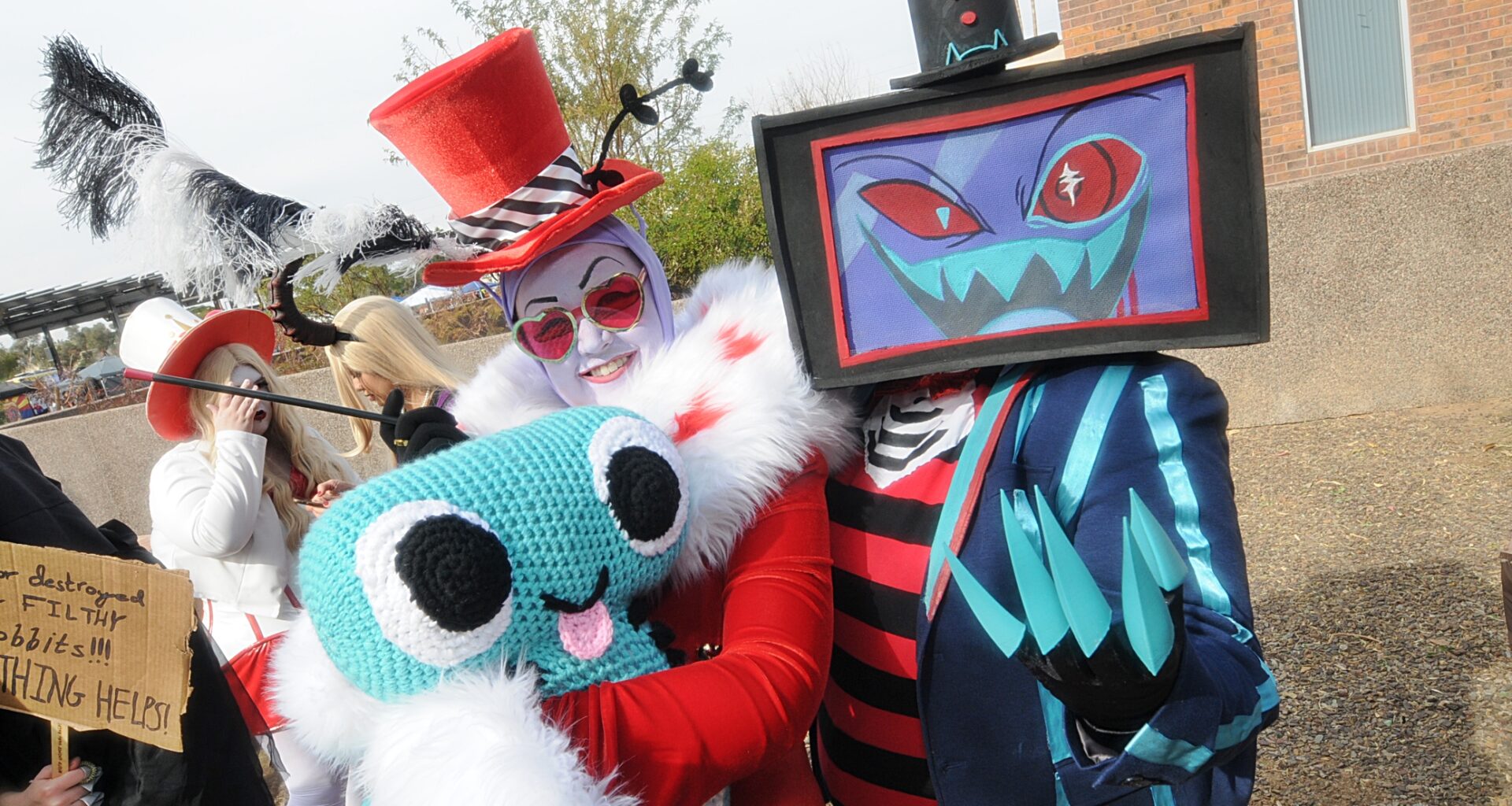 Two cosplayers dressed as characters from "Hazbin Hotel."