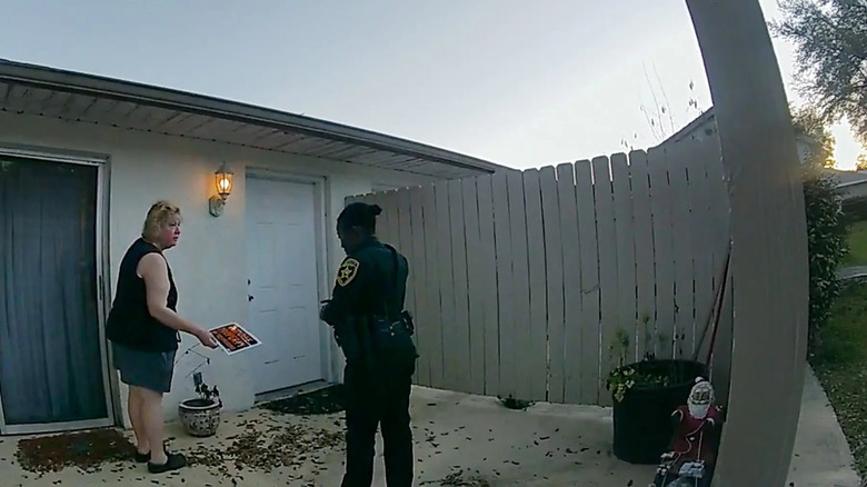 A police officer asking a homeowner a question in The Perfect Neighbor
