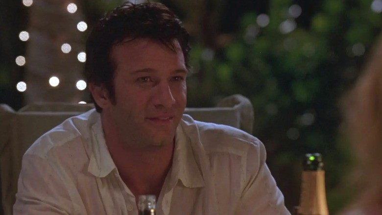 Frank Castle smiles at the dinner table in a pre-vigilante scene of 