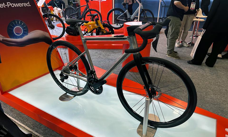 The Titanium Zero sits at a CES display with other e-bikes nearby.