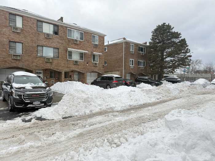 Icy streets and snow mounds line a plowed road in Throggs Neck.