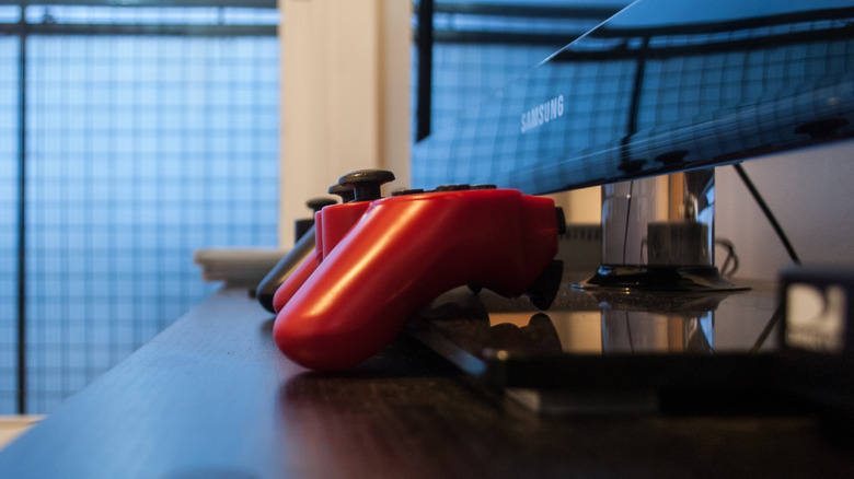 PlayStation 3 controller in front of a TV