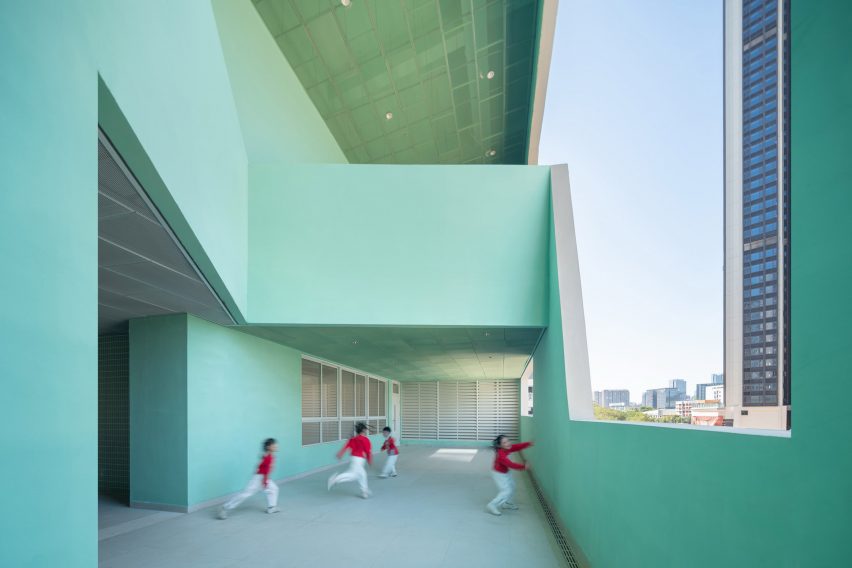 Children playing in turquoise school