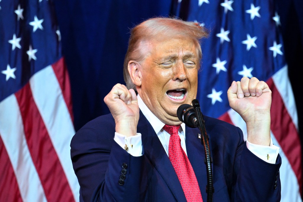 US President Donald Trump reacts as he speaks at the House Republican Party (GOP) member retreat.
